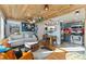 Open-concept living room with wood ceilings, modern furniture, and kitchen in background at 2815 Curtis St, Denver, CO 80205