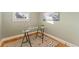 A naturally lit office space with glass desk on patterned rug and hardwood floors at 2815 Curtis St, Denver, CO 80205