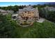 A stunning aerial view of the home showcasing the expansive backyard, lush greenery, and elegant architectural design at 81 Falcon Hills Dr, Highlands Ranch, CO 80126