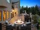 Inviting backyard deck with a cozy fire pit, comfortable seating, and elegant outdoor decor at 81 Falcon Hills Dr, Highlands Ranch, CO 80126