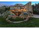 Backyard at dusk featuring decorative lighting in the garden and exterior lighting at 81 Falcon Hills Dr, Highlands Ranch, CO 80126