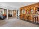 Finished basement with a wooden bar and seating area, perfect for entertaining guests at 81 Falcon Hills Dr, Highlands Ranch, CO 80126