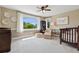 Serene bedroom featuring a crib, an oversized window and a neutral color scheme at 81 Falcon Hills Dr, Highlands Ranch, CO 80126