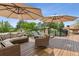 Outdoor deck with patio furniture, umbrellas, and great views at 81 Falcon Hills Dr, Highlands Ranch, CO 80126