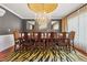 Formal dining room with hardwood floors, elegant chandelier, and ample seating for large gatherings at 81 Falcon Hills Dr, Highlands Ranch, CO 80126