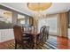 Luxurious dining room with a large table, chandelier, and designer rug at 81 Falcon Hills Dr, Highlands Ranch, CO 80126