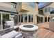 Elegant home exterior with a stone fire pit, comfortable seating, and well-manicured landscaping, perfect for outdoor enjoyment at 81 Falcon Hills Dr, Highlands Ranch, CO 80126