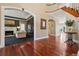 Elegant foyer with gleaming hardwood floors, curved staircase, and views into the formal living room at 81 Falcon Hills Dr, Highlands Ranch, CO 80126
