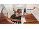 Grand foyer with a curved staircase, wood floors, and an elegant chandelier at 81 Falcon Hills Dr, Highlands Ranch, CO 80126