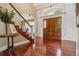 Elegant foyer with hardwood floors, staircase, and grand front door at 81 Falcon Hills Dr, Highlands Ranch, CO 80126