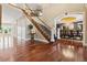 Elegant foyer with hardwood floors, a grand staircase, and views of the dining room at 81 Falcon Hills Dr, Highlands Ranch, CO 80126