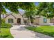 Attractive home exterior with manicured lawn, lush trees, and stone accents at 81 Falcon Hills Dr, Highlands Ranch, CO 80126