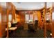 Sophisticated home office featuring wood paneling, custom built-ins, and a comfortable workspace at 81 Falcon Hills Dr, Highlands Ranch, CO 80126