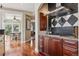 Well-appointed kitchen detail featuring a stainless steel range hood, granite counters, and rich wood cabinetry at 81 Falcon Hills Dr, Highlands Ranch, CO 80126