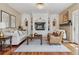 A comfortable living room with a fireplace, wood floors and a decorative wall unit at 81 Falcon Hills Dr, Highlands Ranch, CO 80126