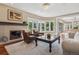 Cozy living room with a fireplace, large windows, and comfortable seating at 81 Falcon Hills Dr, Highlands Ranch, CO 80126