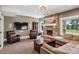 Cozy living room with a stone fireplace, comfortable seating, and a mounted television at 81 Falcon Hills Dr, Highlands Ranch, CO 80126