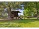 Charming treehouse in a lush backyard, providing a fun and adventurous space for children at 81 Falcon Hills Dr, Highlands Ranch, CO 80126