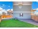 A backyard features low-maintenance turf grass, a gravel area, and a view of the rear exterior of the house at 10124 Xanadu St, Commerce City, CO 80022
