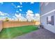 A fenced backyard features low-maintenance turf grass, a gravel area, and a view of neighboring houses at 10124 Xanadu St, Commerce City, CO 80022