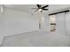 Bright bedroom with a ceiling fan, soft carpet, and sliding barn doors leading to an ensuite bathroom at 10124 Xanadu St, Commerce City, CO 80022