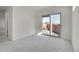 Bright and airy bedroom with sliding glass door leading to outdoor space, neutral walls, and plush carpeting at 10124 Xanadu St, Commerce City, CO 80022