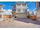Inviting two-story home featuring a spacious two-car garage and charming exterior accents at 10124 Xanadu St, Commerce City, CO 80022