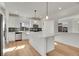 Bright kitchen with stainless steel appliances, island and tile backsplash at 10124 Xanadu St, Commerce City, CO 80022