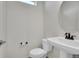 Contemporary powder room featuring a pedestal sink, round mirror, and a neutral color palette at 10124 Xanadu St, Commerce City, CO 80022