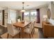 Elegant dining room featuring a wooden table, comfortable chairs, and natural light from windows at 2538 Central Park Boulevard, Denver, CO 80238
