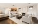 Cozy living room with a fireplace, comfortable seating, and an open view to the kitchen area at 2538 Central Park Boulevard, Denver, CO 80238