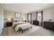 Spacious primary bedroom featuring carpeted floors, bright windows, and tastefully curated furniture at 2538 Central Park Boulevard, Denver, CO 80238