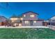 Expansive backyard featuring a deck, patio, and lush green lawn, perfect for outdoor gatherings at 6550 W 74Th Pl, Arvada, CO 80003