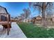 Fenced backyard with deck, shed, playset, and mature tree at 6550 W 74Th Pl, Arvada, CO 80003