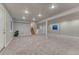 This finished basement has neutral colors, carpeted floors, and recessed lighting throughout at 6550 W 74Th Pl, Arvada, CO 80003
