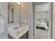 Neat bathroom adjacent to bedroom with bright vanity lighting at 6550 W 74Th Pl, Arvada, CO 80003