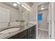 Bathroom featuring double sinks, white subway tile, and modern fixtures at 6550 W 74Th Pl, Arvada, CO 80003