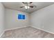 Bedroom featuring plush carpet, ceiling fan with light and natural light from the window at 6550 W 74Th Pl, Arvada, CO 80003