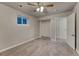 Bedroom with neutral carpet, ceiling fan, closet and access to a hallway at 6550 W 74Th Pl, Arvada, CO 80003