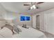 Well-lit bedroom features a plush bed, soft decor, and a large window at 6550 W 74Th Pl, Arvada, CO 80003