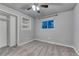 Cozy bedroom with soft carpet, ceiling fan, closet, and window providing outdoor view at 6550 W 74Th Pl, Arvada, CO 80003