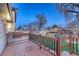 Wooden deck with black railing, overlooking the backyard at 6550 W 74Th Pl, Arvada, CO 80003