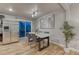 Well-lit dining area features hardwood floors, modern table set and stainless steel refrigerator at 6550 W 74Th Pl, Arvada, CO 80003