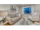 Cozy living room featuring natural light, comfortable seating, and stylish decor at 6550 W 74Th Pl, Arvada, CO 80003