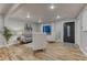 Inviting living room with wood floors, modern decor, neutral colors, and a stylish front door at 6550 W 74Th Pl, Arvada, CO 80003