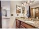 Bathroom boasting granite countertops, wood cabinets, and modern vanity lighting at 11042 Blackwolf Ln, Parker, CO 80138