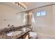 Bathroom with granite counter tops, decorative backsplash and shower and tub combination at 11042 Blackwolf Ln, Parker, CO 80138