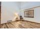 Bright, airy bedroom featuring wood floors, a window with blinds, and ample natural light at 11042 Blackwolf Ln, Parker, CO 80138