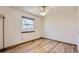 Bedroom featuring a light ceiling fan, warm wooden trim, and bright natural light at 11042 Blackwolf Ln, Parker, CO 80138