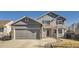 Charming two-story home with a gray exterior, stone accents, and a well-maintained front yard at 11042 Blackwolf Ln, Parker, CO 80138